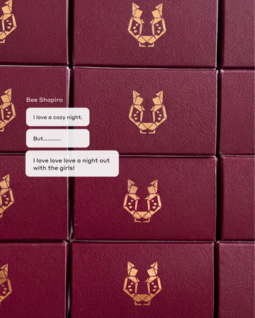 PLUM TONIC eau de parfum burgunday boxes stacked with the Ellis Brooklyn rose gold logo front facing with text message bubbles that read "I love a cozy night." "But......" and "I love love a night out with the girls!"