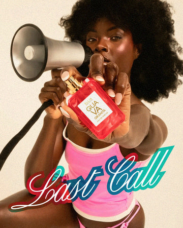 Woman with brown hair and a French manicure wearing a pink and white tank top and pink bikini bottoms holds GUAVA GRANITA Eau de Parfum 50ml without cap out in one hand and a megaphone up to her lips with the other hand on a white background with pink, blue, and white text that reads "Last Call"