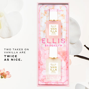 Ellis Brooklyn Twice as Nice gift set containing one 7.5mL mini-Vanilla Salt & 1 7.5mL mini-Vanilla Rice bottles in a pink floral window box packaging, styled with white orchid flowers and vanilla beans on a white background with promotional text in center left of background that reads 