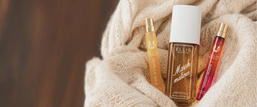 VANILLA MILK 10ml Eau de Parfum, MARSHMALLOWS 90ml Perfume Mist and QUEENS CARAMEL 10ml Eau de Parfum in white knit blanket against brown wood background