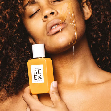 IMAGE 3: MODEL HOLDING BEE 50ML BOTTLE