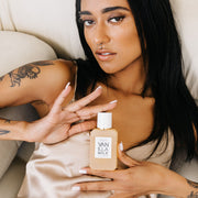 IIMAGE 4: Model holding VANILLA MILK 50ML BOTTLE