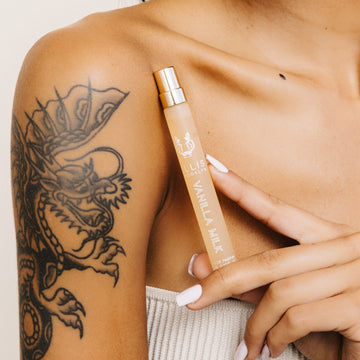 IMAGE 5: MODEL HOLDING VANILLA MILK TRAVEL SPRAY NEAR SHOULDER