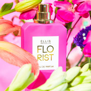 IMAGE 3: FLORIST 50ML BOTTLE WITH FLOWERS AND PINK BACKDROP