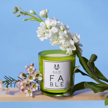 IMAGE 3: FABLE candle near flowers