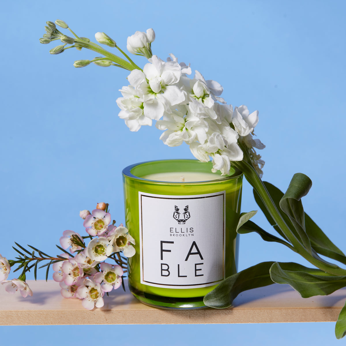 FABLE candle near flowers