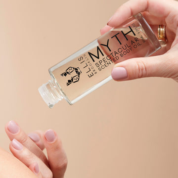 IMAGE 3: MODEL HOLDING MYTH body oil