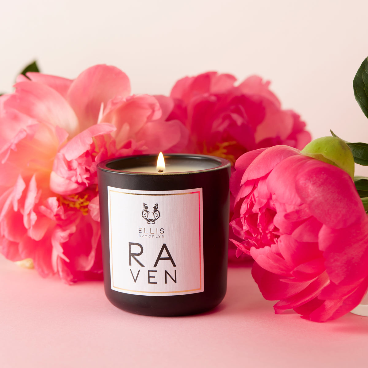 RAVEN candle near flowers