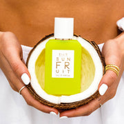 IMAGE 6: MODEL HOLDING SUN FRUIT 50ML BOTTLE IN COCONUT