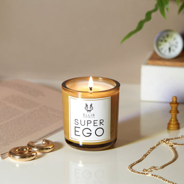 IMAGE 3: SUPEREGO candle NEAR BOOK AND JEWLERY