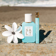 IMAGE 5: SALT 50ml & travel spray at beach WITH FLOWER