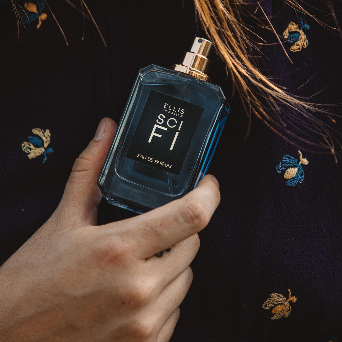 Model holding SCI FI 50ml bottle
